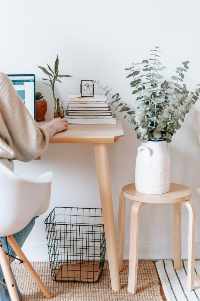 pexels-photo-7034717-7034717 Cozy workspace with a laptop, books, and plants, promoting a relaxed, creative atmosphere.